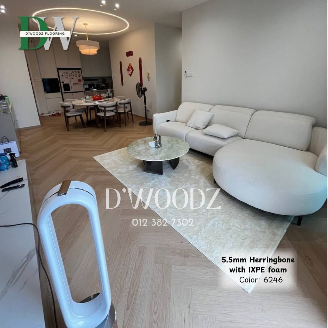 An open living and dining area with a pale herringbone floor, a round table and a ring pendant light; the D'Woodz watermark and product label in frame.
