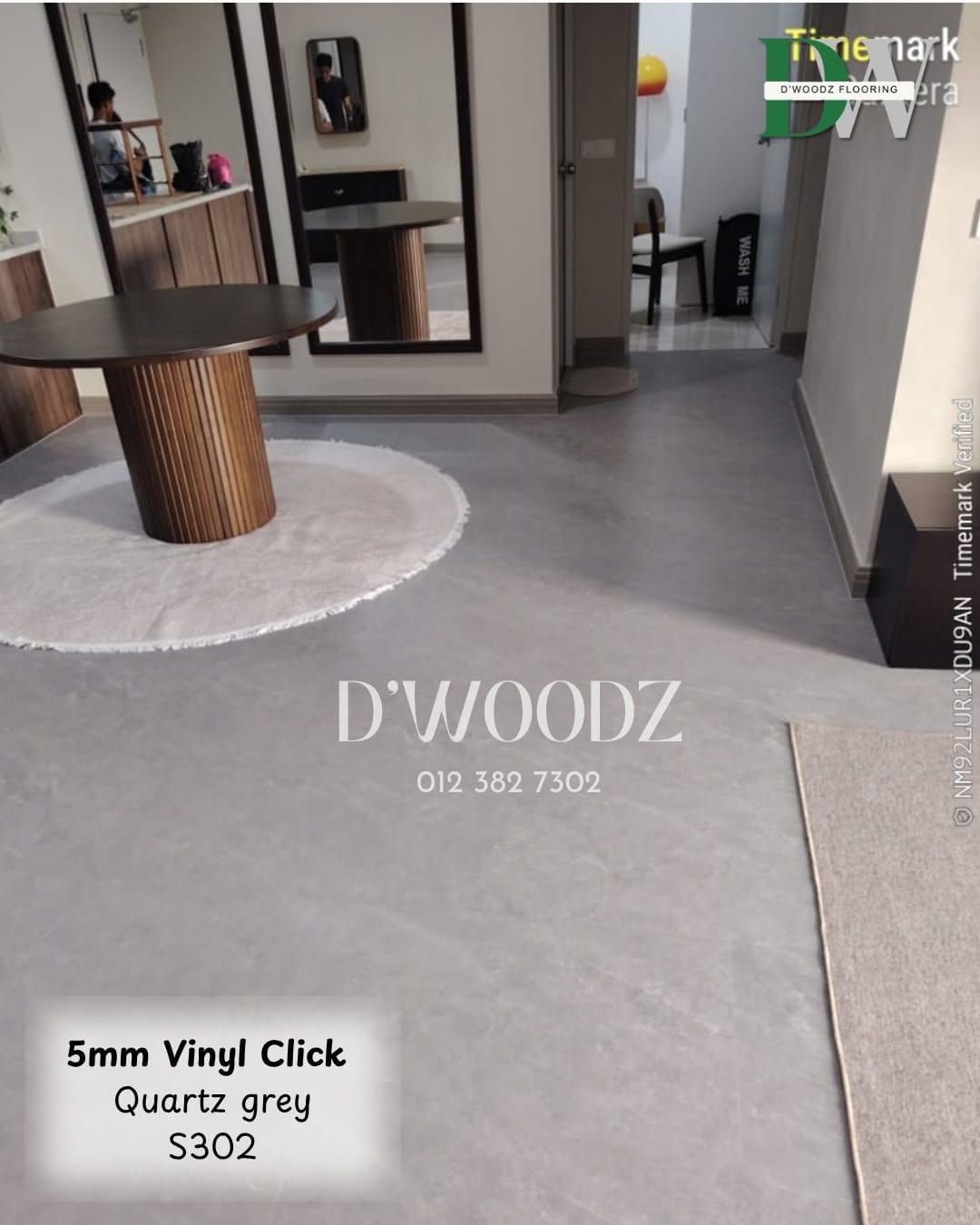 A lounge with a grey marble-effect floor, a round table, a mirror and a pale rug; the D'Woodz watermark and product label in frame.